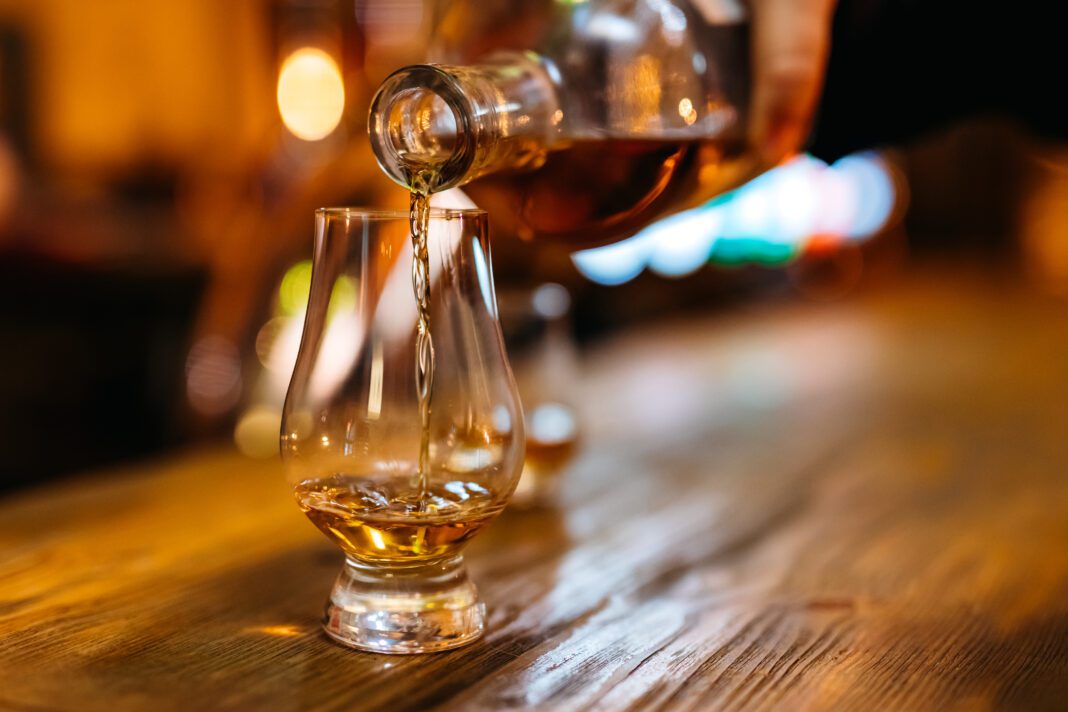 Pouring whiskey in glass