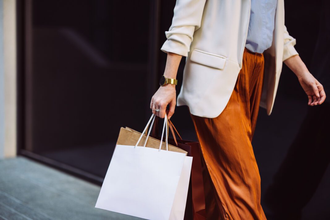 Close Up Photo Of Woman Hands Holding Shopping Bags Outdoors