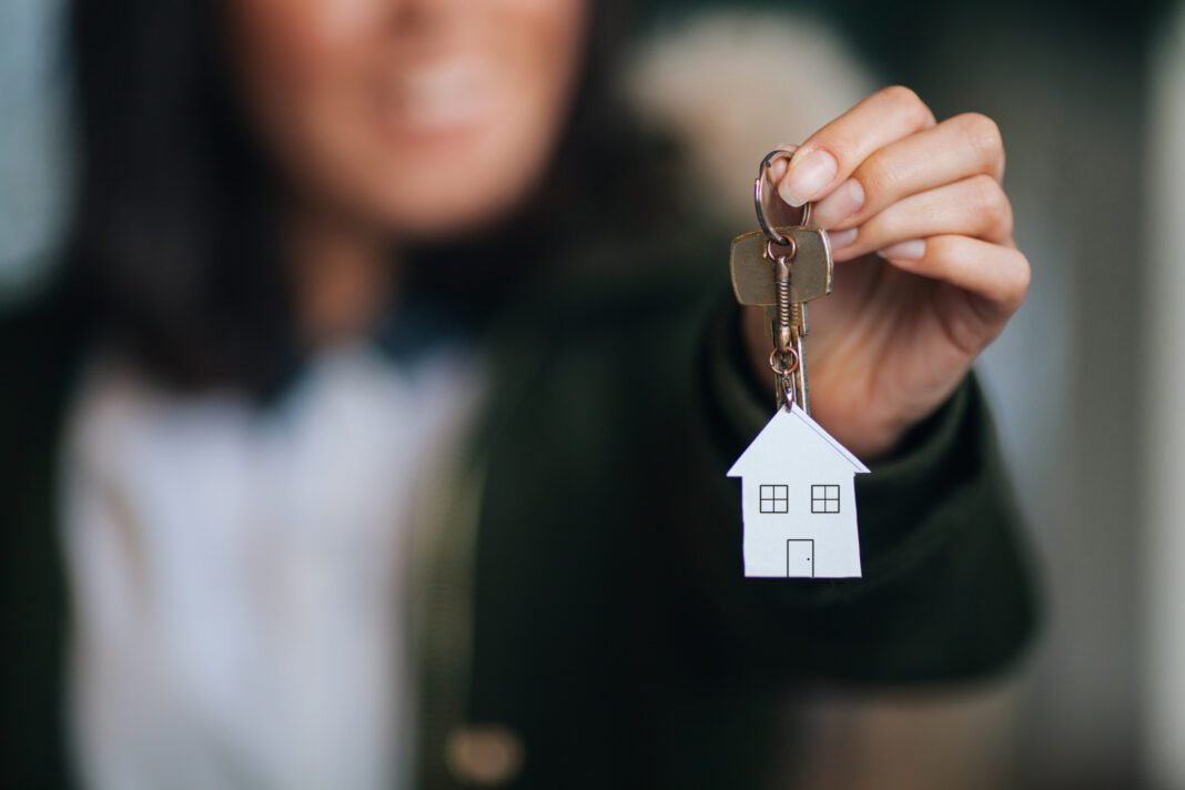 Female hand holding house key