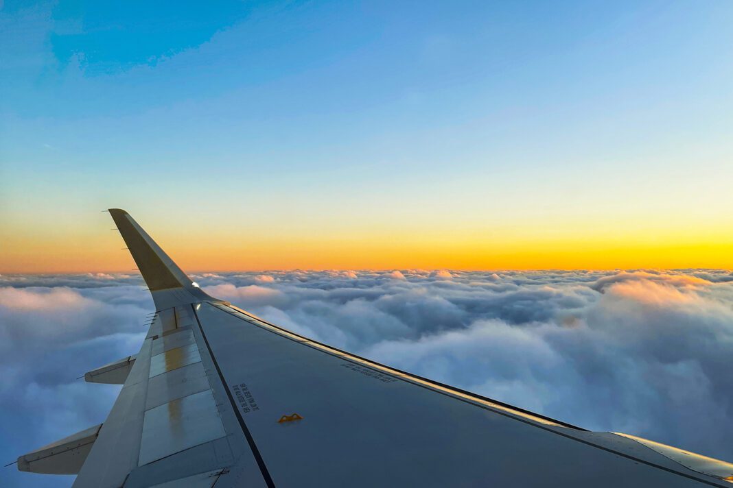 View of the magical clouds at sunset from the airplane window