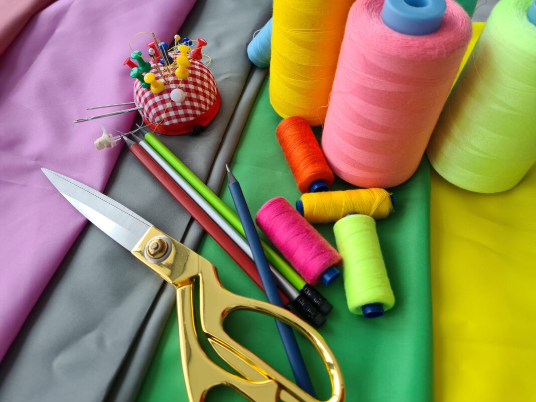 Colorful Sewing Supplies On Green Fabric